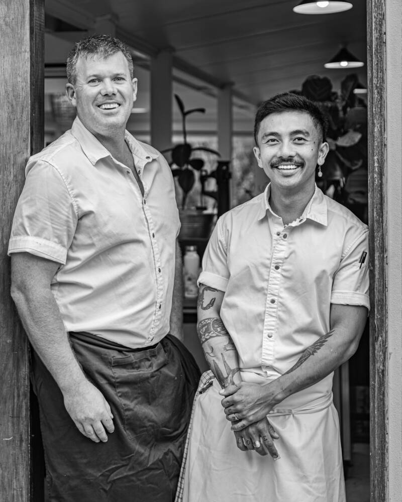 Chefs James Orlowski and Niah Suksawaeng in the doorway of the restaurant