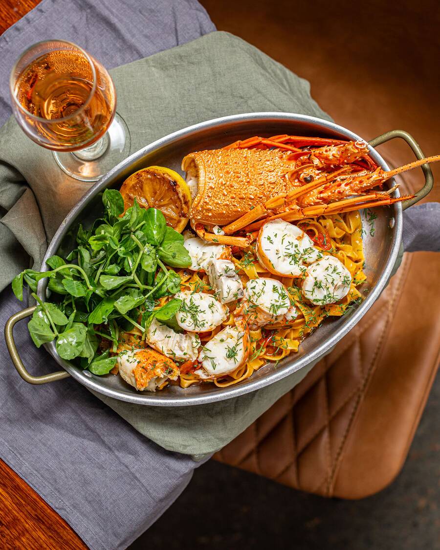 A seafood platter with lobster served at a private dining table at Estancia Adina